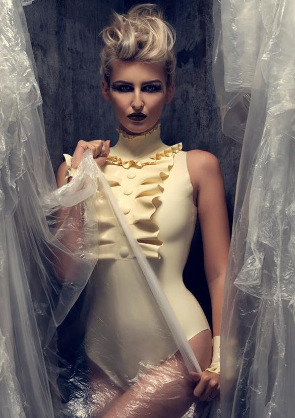 Latex Felice bodysuit with high neck ruffle, in White. Cover buttons.